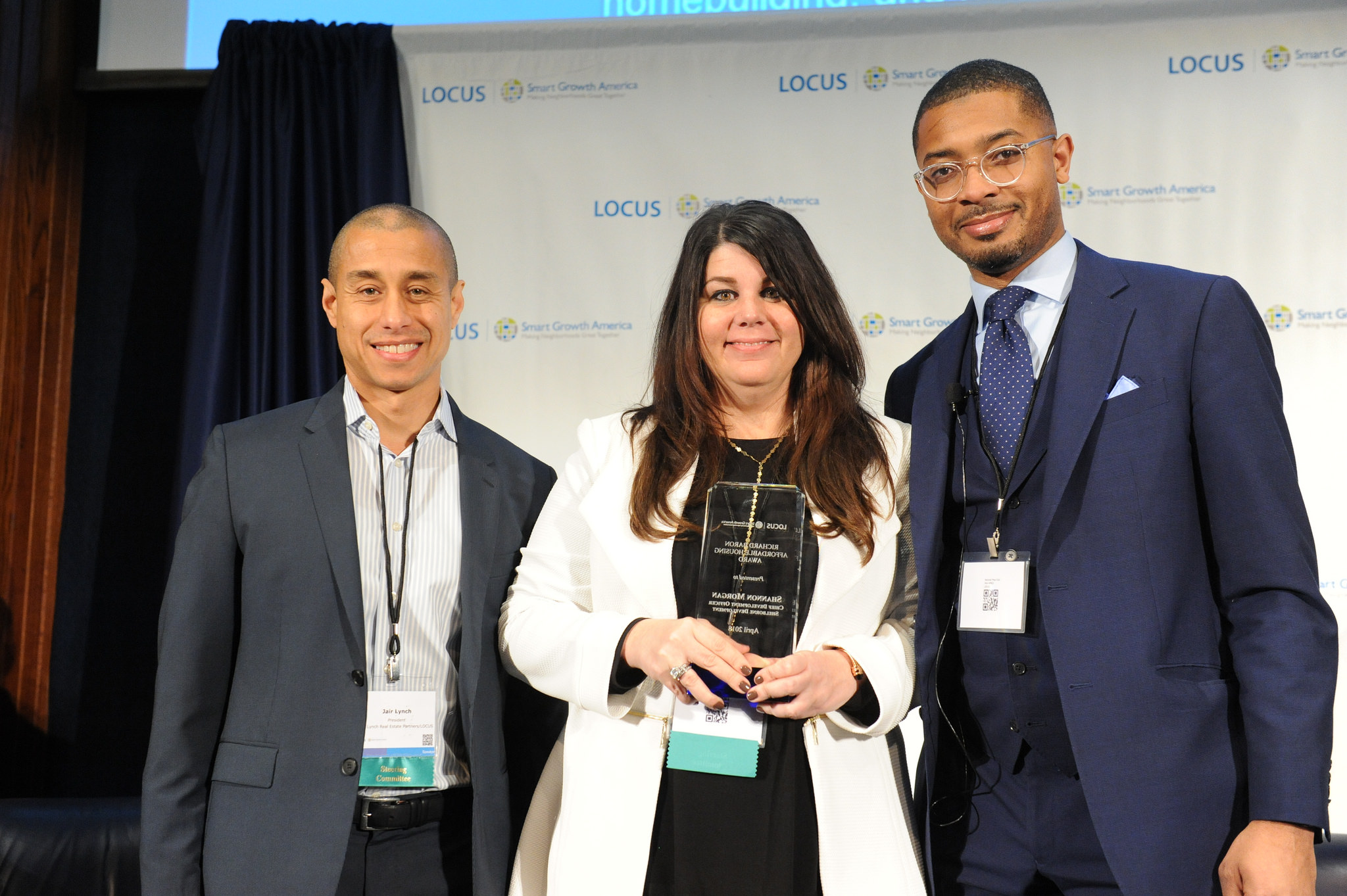  /><span>LOCUS President Jair Lynch (L) and Director Christopher Coes (R) recognize Shannon Morgan, Chief Development Officer at Shelborne Development in Detroit, MI, with the Richard Baron Award for Affordable Housing at the 2018 LOCUS National Leadership Summit.</span></p>
<p>Do you know a real estate developer, investor, or company creating great walkable places and demonstrating exemplary public leadership to advance smart growth development? If so, <a href=