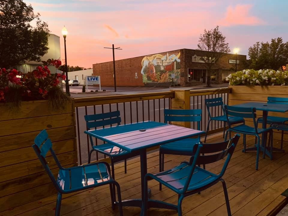 A peaceful calm settles over the Bowling Green Parklets as the sun sets behind an open street free of car traffic