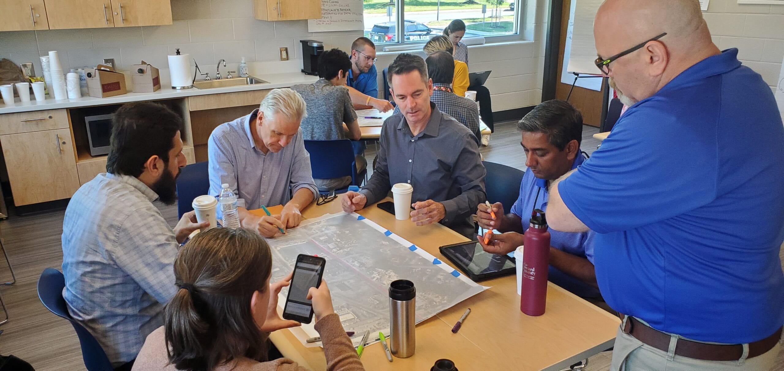 A group of transportation planners and engineers discusses the potential design of a Complete Streets project